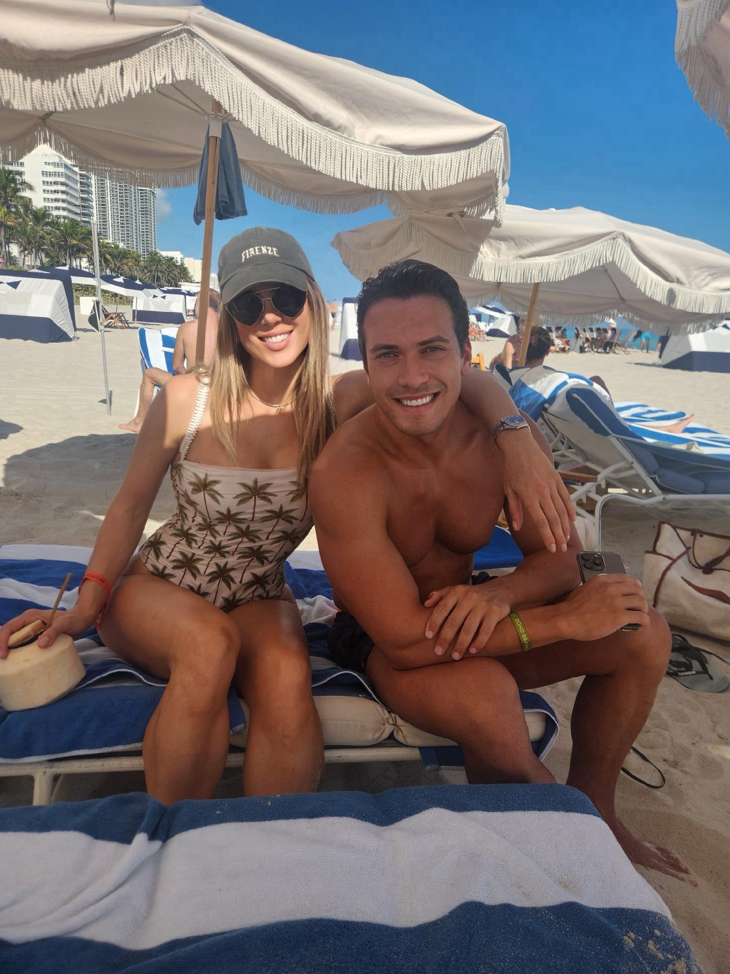 A coconut and a Firenze cap on the beach
